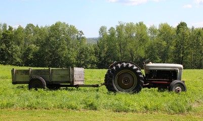tractor and wagon in green field