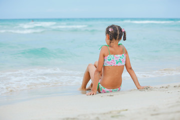 Adorable happy little girl on beach vacation