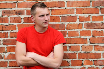 Portrait of a handsome young guy in a red shirt