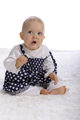 cute baby girl eating a cookie