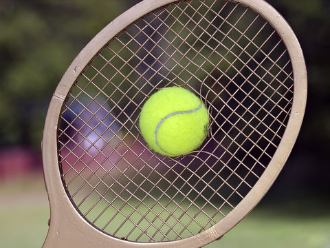 Tennis Ball Breaks Through Racquet Strings