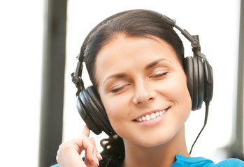 happy teenage girl in big headphones