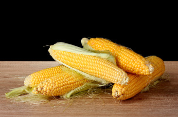 Fresh corn on black background