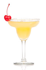 Yellow margarita cocktail with red cherry in chilled salt rimmed
