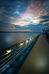 Papier Peint photo Mer / coucher de soleil On the deck of the ship at sunrise