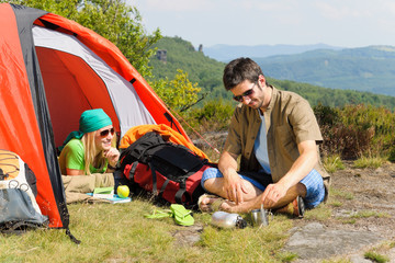 Camping young couple with tent summer countryside