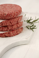 Raw burgers for hamburgers, in a pile