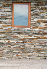 stone wall with glass window and wooden floor