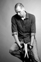 man studying sneakers at shopping