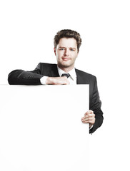 Young businessman holding a blank white board