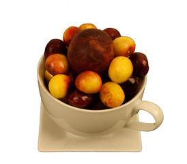 Cherries & plum in a large cup