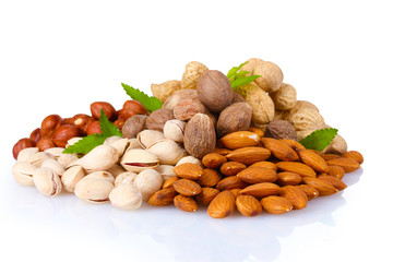 almonds, nutmeg, peanuts and pistachios isolated on white