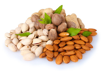 almonds, nutmeg, peanuts and pistachios isolated on white