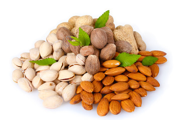 almonds, nutmeg, peanuts and pistachios isolated on white