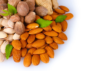 almonds, nutmeg, peanuts and pistachios isolated on white