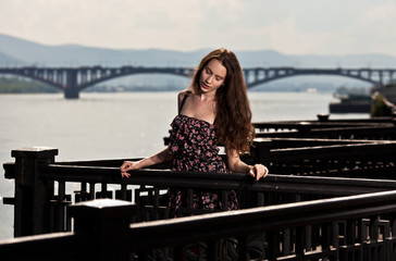 Portrait of the beautiful woman with bridge city background