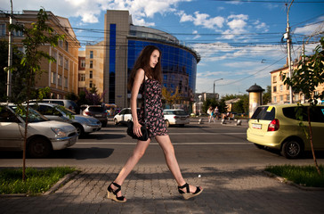 young carefree woman walking at the street in city