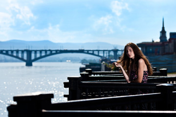 Portrait of the beautiful woman with bridge city background