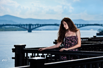 Portrait of the beautiful woman with bridge city background