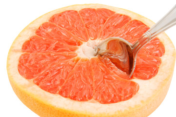 Halved red grapefruit with spoon isolated on white
