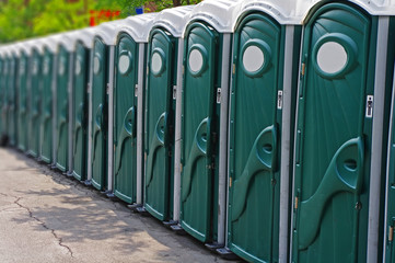 Row of porta potty outhouses ready for use