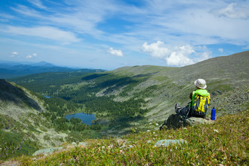 woman sitting on  rock  at mountain peak