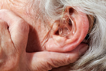 aged woman with hearing aid