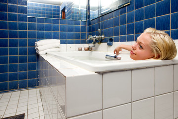 Woman in Bathtub in Blue Room