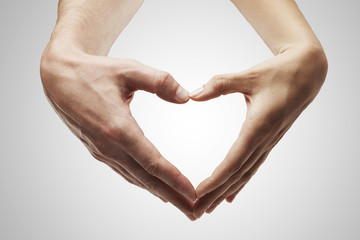 Heart shape  made of  female and male hands together - obrazy, fototapety, plakaty