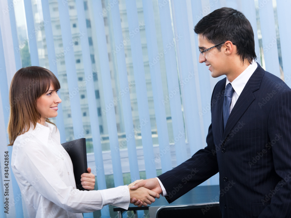 Wall mural two businesspeople, or businessman and client, handshaking