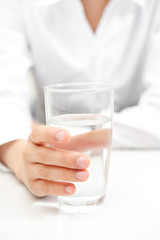 a woman drinking a glass of water