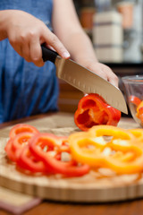 Woman cutting sweet peppers