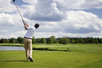 Golfer teeing off