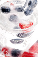 Raspberry and blackberry frozen in ice sticks