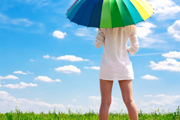 girl in a field with a bright umbrella