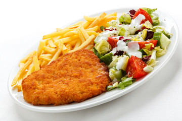 Pork chop, French fries and vegetables