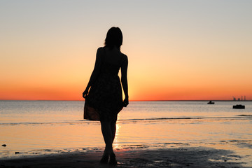 Portrait of young woman as silhouette by the sea