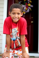 Young boy with hands on knees