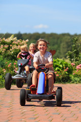 girls with toy cars outdoor smiling