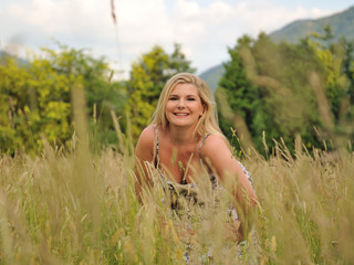 Pretty summer woman on yellow wheat field in countryside relaxin