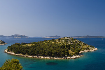 Green island in the aquamarine sea