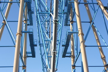 Ferris wheel against a blue sky in the amusement park