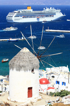 huge cruise ship and a windmill in mykonos