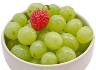 Grape and strawberry in a white cup