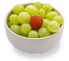 Grape and strawberry in a white cup