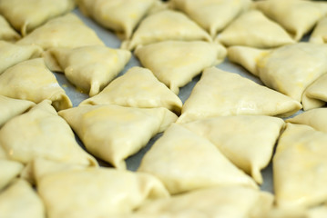 dough with minced meat patties cooking Asian samsa