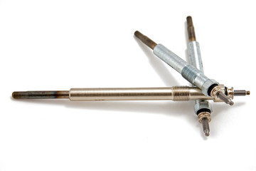 three  glow plugs on white background