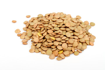 Pile of green lentils from low perspective isolated on white.