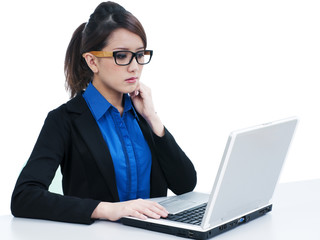 Attractive young businesswoman using laptop