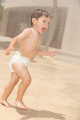 Cute baby boy having fun in a water park